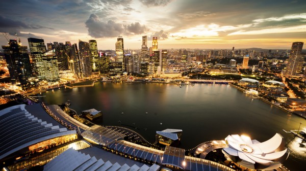 Aerial view of Singapore's Marina Bay with the beautiful Skyline illuminated at sunset. Backlit shot with wide-angle lens used for a greater panoramic impression.