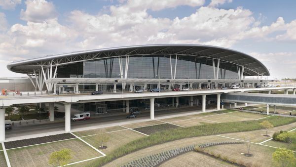 Indianapolis, United States - September 12, 2011: The Colonel H. Weir Cook Terminal is gracefully situated between the runways of Indianapolis International Airport. Passengers travel above sculpted grounds along the enclosed pedestrian bridge (right) that connects the terminal to the parking structure.