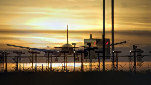 Airplane approaching the landing strip at sunset. Heathrow, London, UK (iStock)