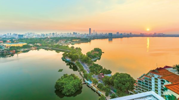 A panorama of Hanoi’s West Lake at sunset – Credit iStock.com/HuyThoai