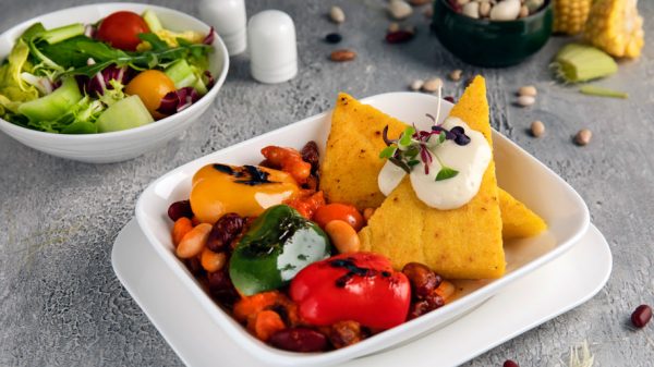 Emirates Veganuary - Ancho three bean chilli, a spiced vegan stew of peppers and beans served with corn cakes, chimichurri and tofu aioli
